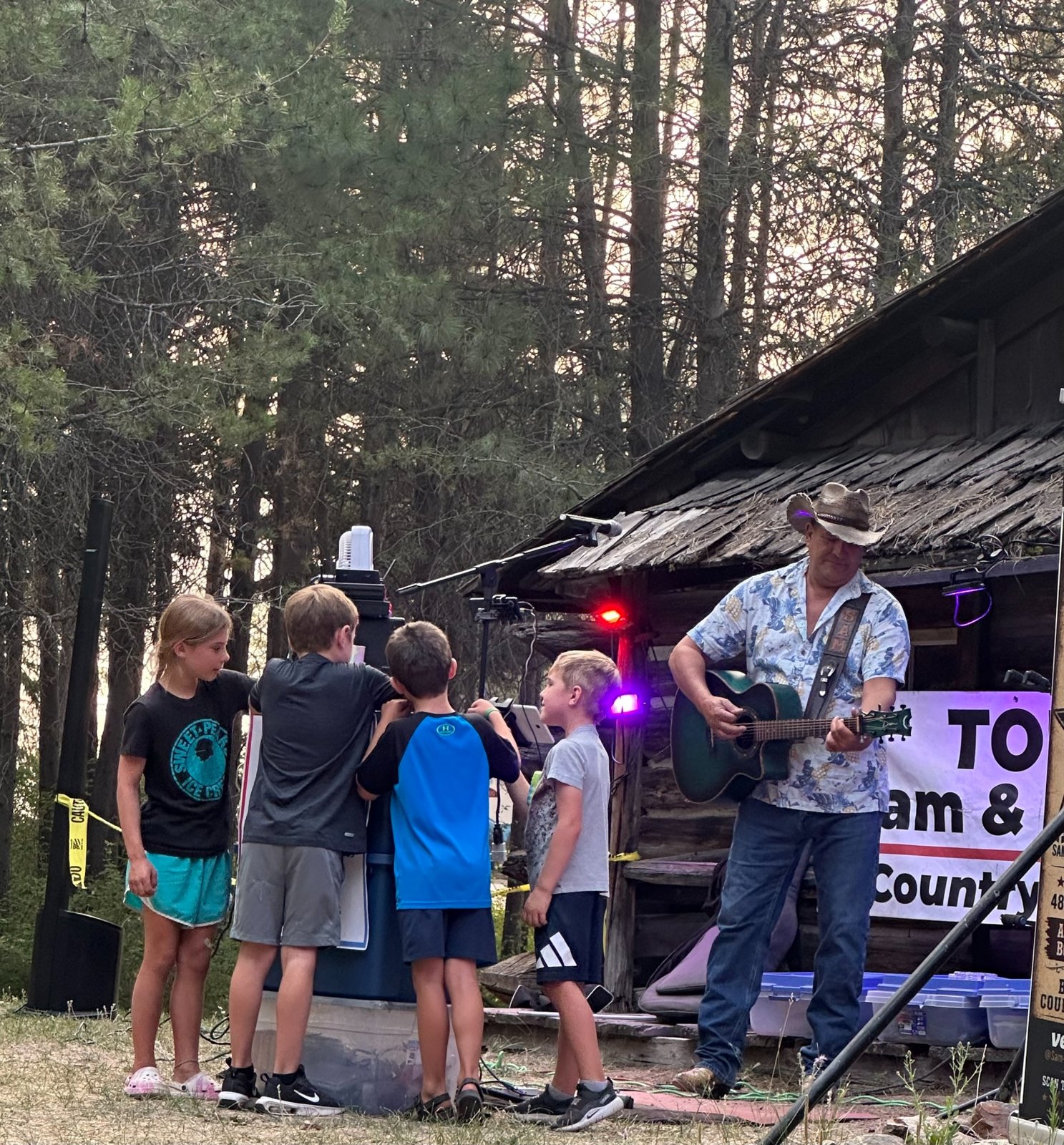 Sam performing and audiences enjoying live music