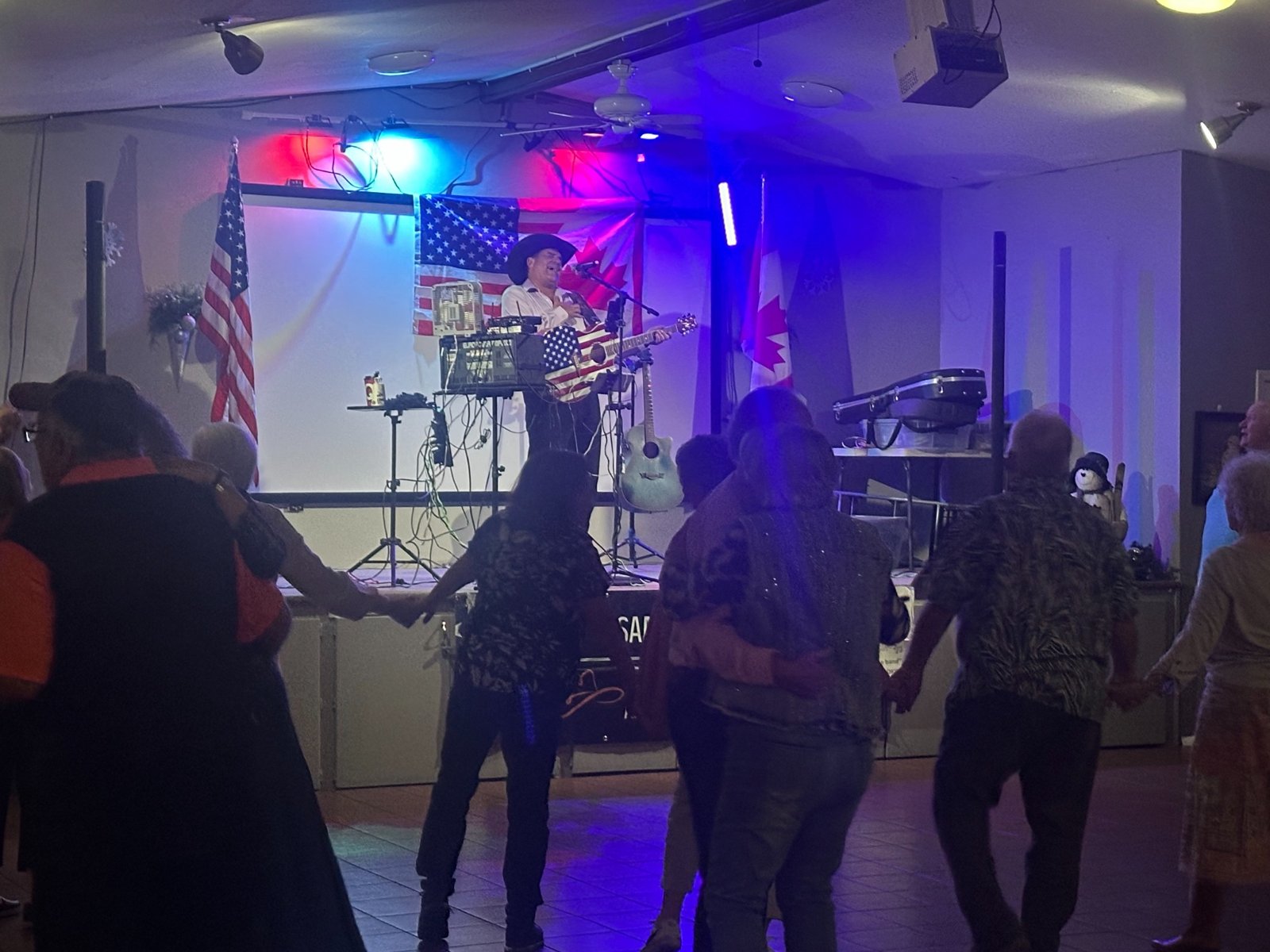 Sam performing and audiences enjoying live music