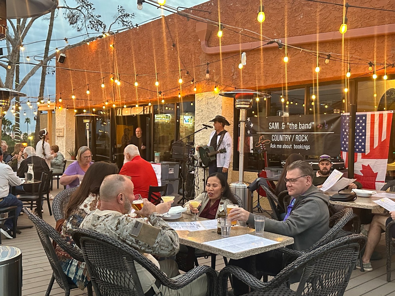 Sam performing and audiences enjoying live music